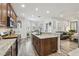 Open kitchen concept flows into breakfast nook and Gathering room with stainless appliances and granite countertops at 10422 Fenceline Rd, New Port Richey, FL 34655