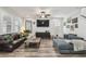 Living room featuring hardwood flooring, a ceiling fan, and stylish furniture at 10422 Fenceline Rd, New Port Richey, FL 34655