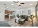 Open-concept space integrating a living room and kitchen with breakfast bar seating at 10422 Fenceline Rd, New Port Richey, FL 34655