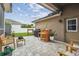 Stylish outdoor patio with string lights, a grill, and comfortable seating at 10422 Fenceline Rd, New Port Richey, FL 34655