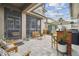 Charming outdoor patio with string lights, comfortable seating, and lush greenery at 10422 Fenceline Rd, New Port Richey, FL 34655