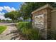 Entrance sign to Longleaf community is surrounded by lush landscaping, offering a welcoming street view at 10422 Fenceline Rd, New Port Richey, FL 34655
