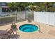An inviting community spa with comfortable seating, surrounded by well-maintained landscaping and fencing at 10422 Fenceline Rd, New Port Richey, FL 34655