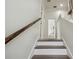 Bright staircase featuring hardwood steps and white risers leading to the upper level at 10422 Fenceline Rd, New Port Richey, FL 34655