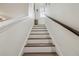 Staircase with wood and white trim and handrail at 10422 Fenceline Rd, New Port Richey, FL 34655