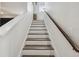 Stairway with wood treads and white risers leading to the upper level at 10422 Fenceline Rd, New Port Richey, FL 34655