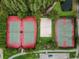 Overhead view of tennis, volleyball and basketball courts and mature trees create a private atmosphere at 10422 Fenceline Rd, New Port Richey, FL 34655