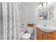 Bathroom with tiled shower, vanity, lighting, mirror, and toilet at 1044 Kennewick Ct, Wesley Chapel, FL 33543