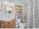 Bright bathroom featuring vanity, a toilet with shelves and a tiled shower and tub at 1044 Kennewick Ct, Wesley Chapel, FL 33543