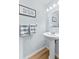 A charming powder room featuring a pedestal sink and decorative accents at 1044 Kennewick Ct, Wesley Chapel, FL 33543