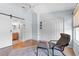 Comfortable bedroom with closet, barn door to bathroom, wood floors, and sitting area at 1044 Kennewick Ct, Wesley Chapel, FL 33543