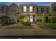 Charming townhouse featuring manicured landscaping, a decorative wreath and American flag at 1044 Kennewick Ct, Wesley Chapel, FL 33543