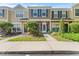 Inviting townhouse exterior with manicured landscaping and charming curb appeal at 1044 Kennewick Ct, Wesley Chapel, FL 33543