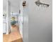 Hallway with wood floors, a key rack, and a glimpse of a living room area at 1044 Kennewick Ct, Wesley Chapel, FL 33543