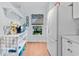 Bright kitchen area with white appliances, window and a decorative shelf at 1044 Kennewick Ct, Wesley Chapel, FL 33543