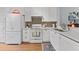 Well-lit kitchen featuring white cabinets, stainless steel appliances, and stylish backsplash at 1044 Kennewick Ct, Wesley Chapel, FL 33543