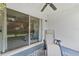 Relaxing patio with ceiling fan, sliding glass door and comfortable lounge chair at 1044 Kennewick Ct, Wesley Chapel, FL 33543