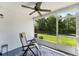 Inviting screened porch with ceiling fan and view of the outdoor landscape at 1044 Kennewick Ct, Wesley Chapel, FL 33543