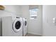 Convenient laundry room with modern washer and dryer, plus plenty of natural light at 10457 Gentle Rain Dr, Land O Lakes, FL 34638