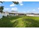 Expansive backyard featuring a well-maintained lawn, a screened porch, and privacy fencing at 11226 Murraysville Dr, Spring Hill, FL 34609