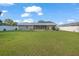 Expansive backyard with a well-maintained lawn and a screened patio offering privacy and outdoor enjoyment at 11226 Murraysville Dr, Spring Hill, FL 34609