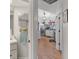 Bathroom view leading to the kitchen, boasting wooden floors and stainless steel appliances for modern convenience at 11226 Murraysville Dr, Spring Hill, FL 34609