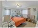Bright bedroom with charming decor has soft carpet and a seating area for relaxation at 11226 Murraysville Dr, Spring Hill, FL 34609