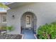 Close-up of the front door and porch area showcasing the home's entrance and surrounding landscaping at 11226 Murraysville Dr, Spring Hill, FL 34609