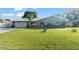 Charming single-story home featuring a metal roof and lush green lawn, providing great curb appeal at 11226 Murraysville Dr, Spring Hill, FL 34609