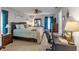 Well-lit main bedroom offering a comfortable space with neutral tones, a ceiling fan, and cozy carpeting at 11226 Murraysville Dr, Spring Hill, FL 34609