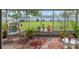 Relax on this screened patio featuring cozy seating, plants, and lovely outdoor views for perfect outdoor living at 11226 Murraysville Dr, Spring Hill, FL 34609