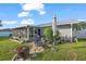 Relaxing patio area with a fire pit, lounge chair, and access to the screened porch at 11226 Murraysville Dr, Spring Hill, FL 34609