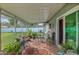 Comfortable screened patio with stylish furnishings, potted plants, and lots of natural light for peaceful relaxation at 11226 Murraysville Dr, Spring Hill, FL 34609
