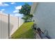 Side yard features a well-kept lawn and a tall vinyl fence for added privacy at 11226 Murraysville Dr, Spring Hill, FL 34609