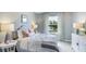Serene bedroom with soft colors, decorative pillows, and bright window views at 11399 Velvet Apricot Dr, Land O Lakes, FL 34638