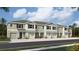 These modern townhomes feature attached garages, stone veneer accents, and well-manicured green spaces at 11399 Velvet Apricot Dr, Land O Lakes, FL 34638