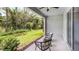 Relaxing covered lanai with cozy chairs overlooking a lush green yard at 11399 Velvet Apricot Dr, Land O Lakes, FL 34638