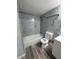 Modern bathroom with tiled shower-tub combination, new toilet, and vinyl flooring at 1215 Windsor Cir, Brandon, FL 33510