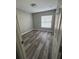 Comfortable bedroom with wood-look flooring and large window that provides plenty of natural light at 1215 Windsor Cir, Brandon, FL 33510