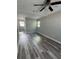 Bright bedroom featuring wood-look floors, modern ceiling fan, and neutral walls at 1215 Windsor Cir, Brandon, FL 33510