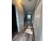 Hallway with wood-look flooring leading to a bedroom with a fan at 1215 Windsor Cir, Brandon, FL 33510