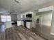 Bright kitchen featuring stainless steel appliances, granite countertops, and new wood-look vinyl flooring at 1215 Windsor Cir, Brandon, FL 33510