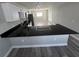A bright kitchen with black countertops, stainless steel appliances, and a spacious breakfast bar at 1215 Windsor Cir, Brandon, FL 33510