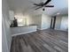 Open-concept living room with wood-look flooring and a breakfast bar that overlooks the kitchen at 1215 Windsor Cir, Brandon, FL 33510