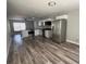 Spacious living room featuring new wood-look vinyl flooring, modern ceiling fan, and an open-concept design at 1215 Windsor Cir, Brandon, FL 33510