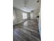 Spacious living room with wood-look flooring and natural light, offering a cozy and inviting atmosphere at 1215 Windsor Cir, Brandon, FL 33510