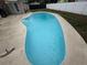 Inviting inground pool features a unique shape and a clean, concrete surround at 1215 Windsor Cir, Brandon, FL 33510