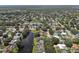 Aerial view displays homes with private pools along canal in a residential Dunedin neighborhood at 1286 Stony Brook Ln, Dunedin, FL 34698