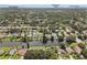 Aerial view showcasing Dunedin neighborhood homes situated on a canal with Honeymoon Island in the background at 1286 Stony Brook Ln, Dunedin, FL 34698