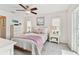 Cozy bedroom with a ceiling fan, neutral decor, and lots of natural light at 1286 Stony Brook Ln, Dunedin, FL 34698